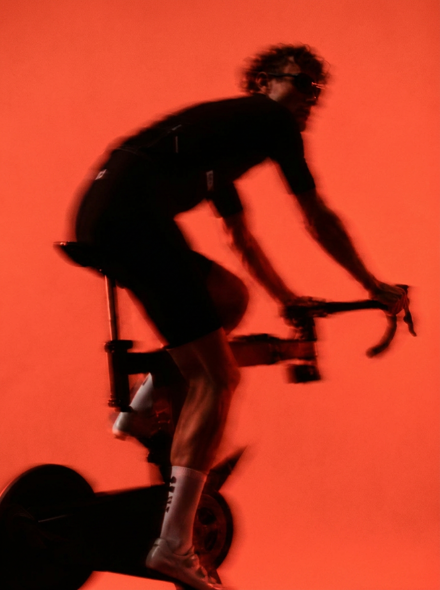 Athletes captured in long-exposure motion under red light